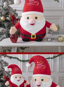 Detail of plush Santa Claus dolls with Merry Christmas embroidery in a festive setting