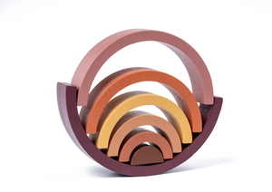 Close-up of wooden rainbow stacking toy with six earth-toned arches on white background