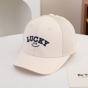 Detail of LUCKY letter embroidery and breathable mesh on a beige kids' trucker cap