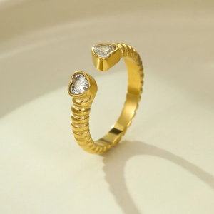 Detail of gold-plated open ring featuring textured band and sparkling heart zircon stones