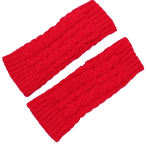 Detail of red cable knit fingerless gloves showing thick woolen texture and elastic cuffs