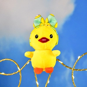 Detailed view of a cute yellow duck plush pendant wearing a mint green bow headband.