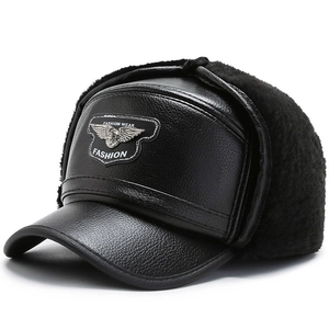Detail of black faux leather aviator hat with warm faux fur lining and metal logo