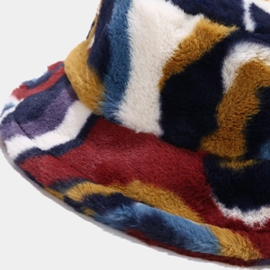 Close-up of soft plush bucket hat showing colorful letter print and fuzzy faux fur texture