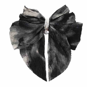 Detail of chiffon bow hair clip with ink gradient print and pearl bead accents