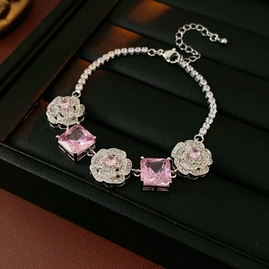 Detail shot of vintage silver bracelet featuring pink rose zircon and square gemstones