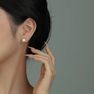 Elegant s925 silver triangle zircon stud earrings worn by a model in a side profile view
