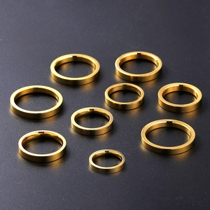 Polished 3mm gold titanium steel ring set of nine pieces on a dark background
