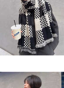 Detail shot of black and white checkerboard knit scarf with elegant fringe edge finish