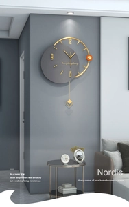 Modern Nordic wall clock featuring dark grey dial, gold metal rings and a sleek pendulum