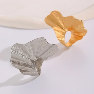 Detailed view of ginkgo leaf rings in gold and silver finish with textured veins