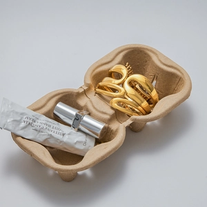 Detail of gold double-layer spring bangles on eco-friendly tray with polished finish