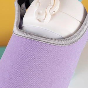 Close-up of purple fabric water bottle sleeve with grey trim and precise stitching