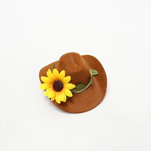 Close-up of a brown felt mini wine bottle hat featuring a yellow sunflower and green leaves