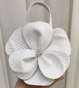 Macro shot of white 3D floral tote bag with textured petals and leather top handle