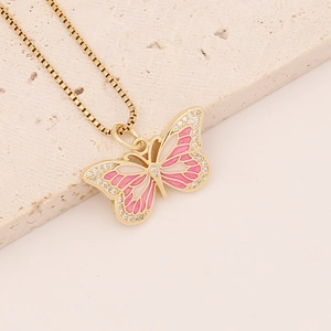 Detail of pink and white enamel butterfly pendant with gold plating and cubic zirconia