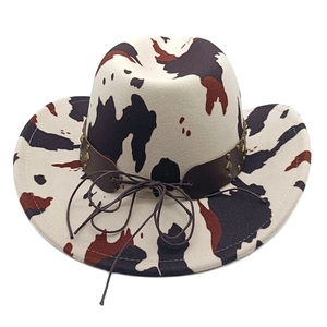 Detail of western wool hat featuring cow print texture and studded leather band