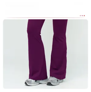Detail of flared cuffs on purple high-waisted yoga pants for a leg-lengthening effect