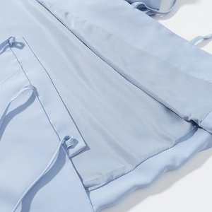 Detailed close-up of light blue fabric texture and smooth inner lining for women's set