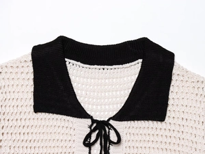 Close-up of contrast polo collar with tie-up detail on hollow knit crochet cardigan