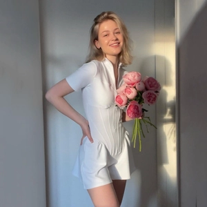 Slim fit white short sleeve bodysuit with zipper front and cinched waist detailing
