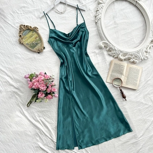 Dark green satin slip nightdress with cowl neck and high slit on a white hanger