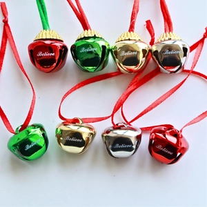 Set of 8 colorful metal Christmas bells with Believe engraving and red hanging ribbons