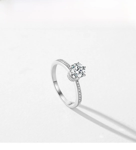 Top view of a silver crown engagement ring with six-prong set crystal and side diamonds