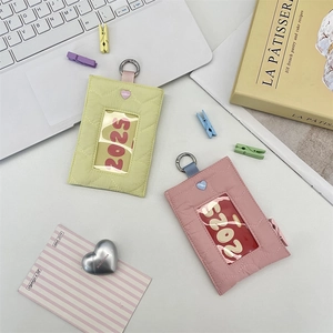 Detailed view of quilted heart ID card holders with clear window and metal ring hook