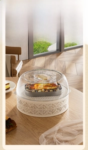 Detailed view of luxury transparent food cover with gold handle and hollow carved base