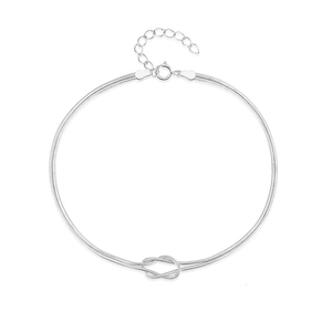 Detail of silver S925 snake chain bracelet featuring a minimalist knot and spring clasp