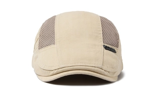 Detail of beige mesh flat cap showing breathable texture and metallic side emblem