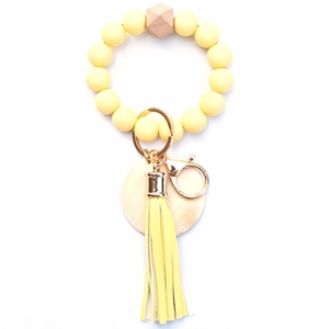 Silicone bead keychain bracelet with yellow leather tassel and wooden charm detail