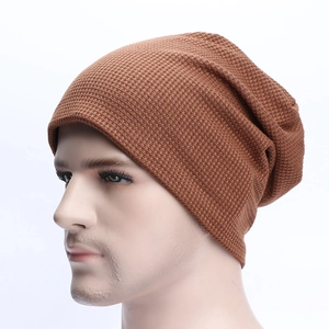 Detailed view of brown waffle knit slouchy beanie with textured thermal fabric