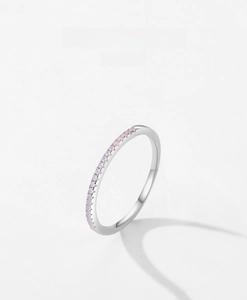Close-up of minimalist S925 sterling silver ring with a row of soft pink opals