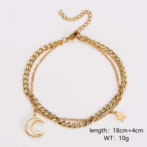 Detailed view of golden double-layer chain bracelet with star and moon mother-of-pearl charms