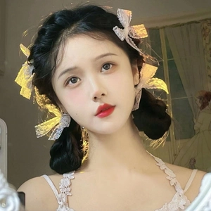Close-up of a white lace bow hair clip worn by a girl in sweet Lolita style fashion