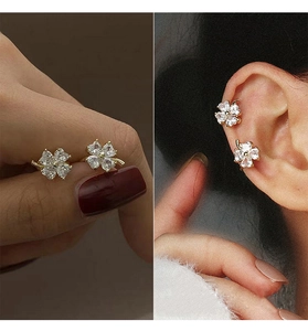 Detailed macro view and on-ear look of clover-shaped earrings with sparkling zircon stones