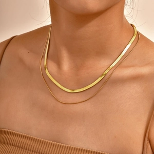 Double layered gold snake bone necklace for women showing sleek metallic finish and drape