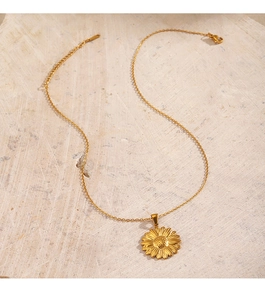 Detailed view of 18K gold plated sunflower pendant on a fine stainless steel chain