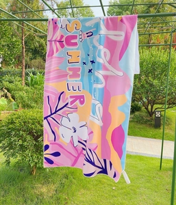Outdoor view of a microfiber beach towel with summer prints and vibrant colorful patterns