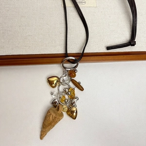 Bohemian mixed pendant necklace with heart charms and beads on dark brown leather cord