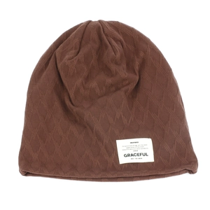 Detail of coffee brown beanie showing diamond knit texture and white graceful label