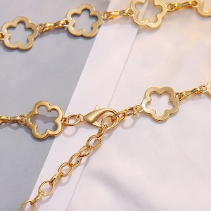 Elegant gold flower chain belt for dresses featuring metallic link patterns and lobster clasp