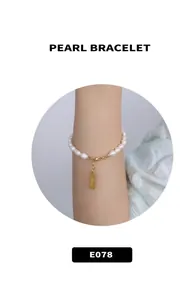 Eleganter Perlenarmband mit goldenem Karabinerverschluss und graviertem Metallanhänger