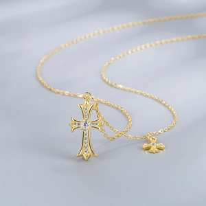 Elegant gold S925 sterling silver cross necklace with pavé diamonds on silk background