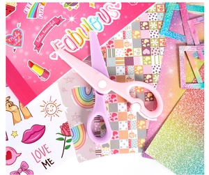 Pink and purple safety scissors for kids DIY journal set placed on colorful craft stickers