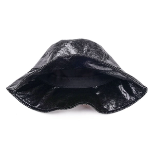 Detailed view of glossy black bucket hat showing metallic texture and interior lining