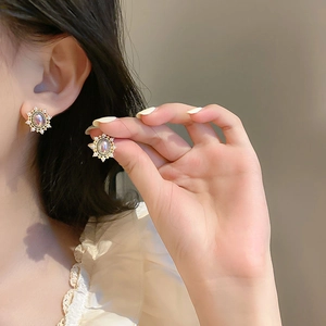 Vintage gold starburst stud earrings with iridescent opal stone and pavé crystal halo
