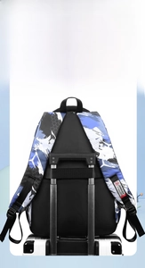 Detail showing back luggage strap of geometric camouflage backpack on suitcase
